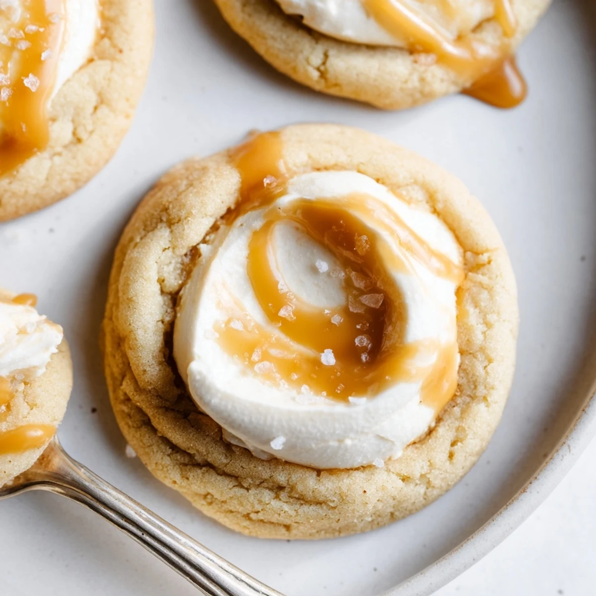 Golden-baked caramel cheesecake cookies topped with melted caramel and creamy cheesecake filling