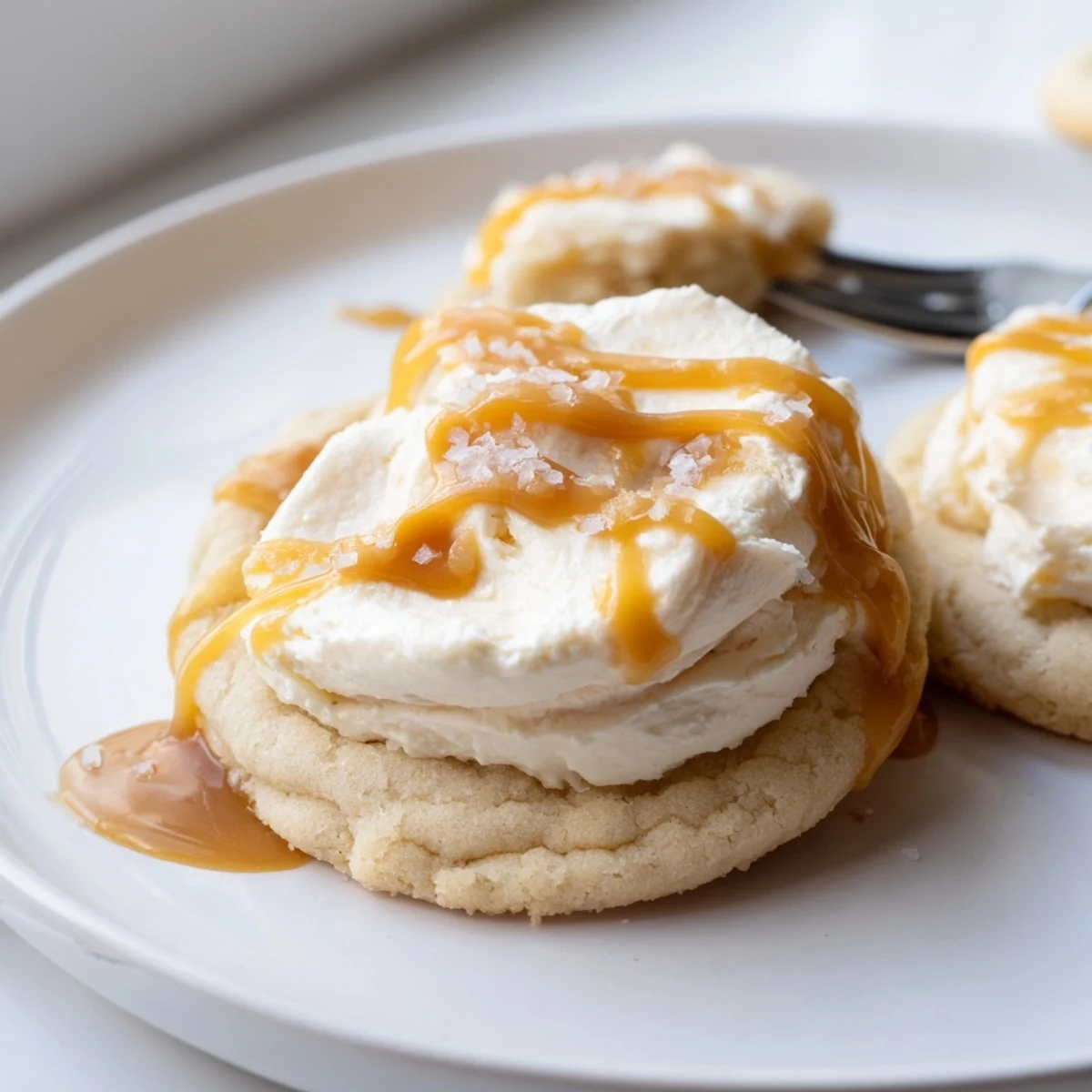 Creamy caramel cheesecake cookies cooling on a wire rack with luscious caramel swirls