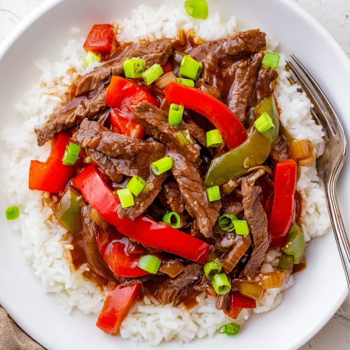 Slow Cooker Pepper Steak with tender beef and colorful bell peppers in savory sauce
