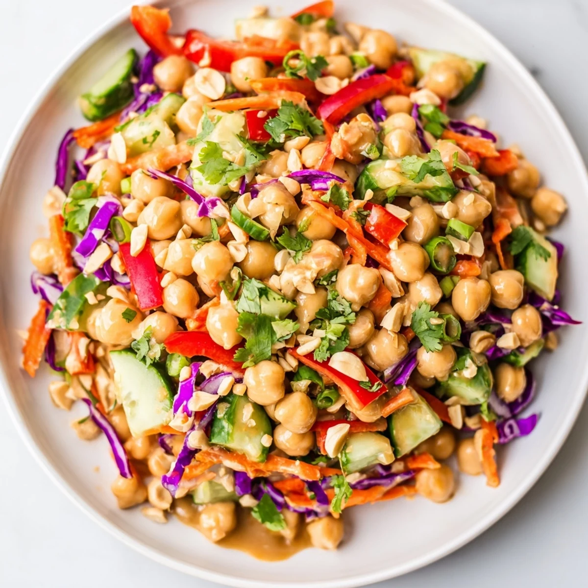 Crunchy Thai Chickpea Salad topped with peanuts and creamy peanut dressing