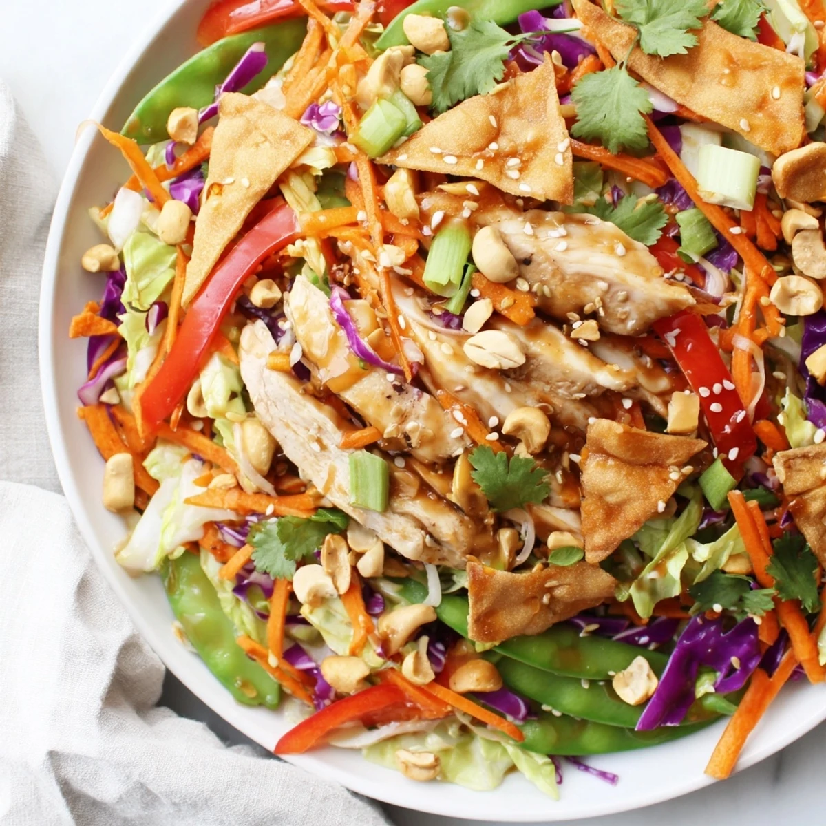 Vibrant chicken cashew crunch salad in a bowl drizzled with tangy soy-sesame glaze