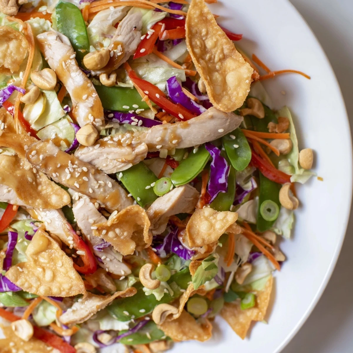 Golden seared chicken slices nestled in crisp vegetables with crunchy cashews throughout