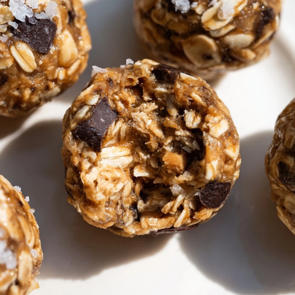 Decadent Snickers energy balls rolled with chocolate chips and roasted peanuts