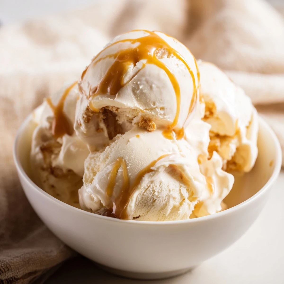 Homemade halal no churn salted caramel ice cream topped with extra sauce.